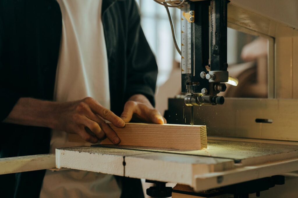 A craftsman skillfully working with wood in an indoor workshop setting.